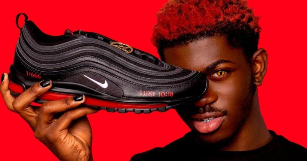 Lil Nas X showing the all-seeing eye symbol during a Nike commercial